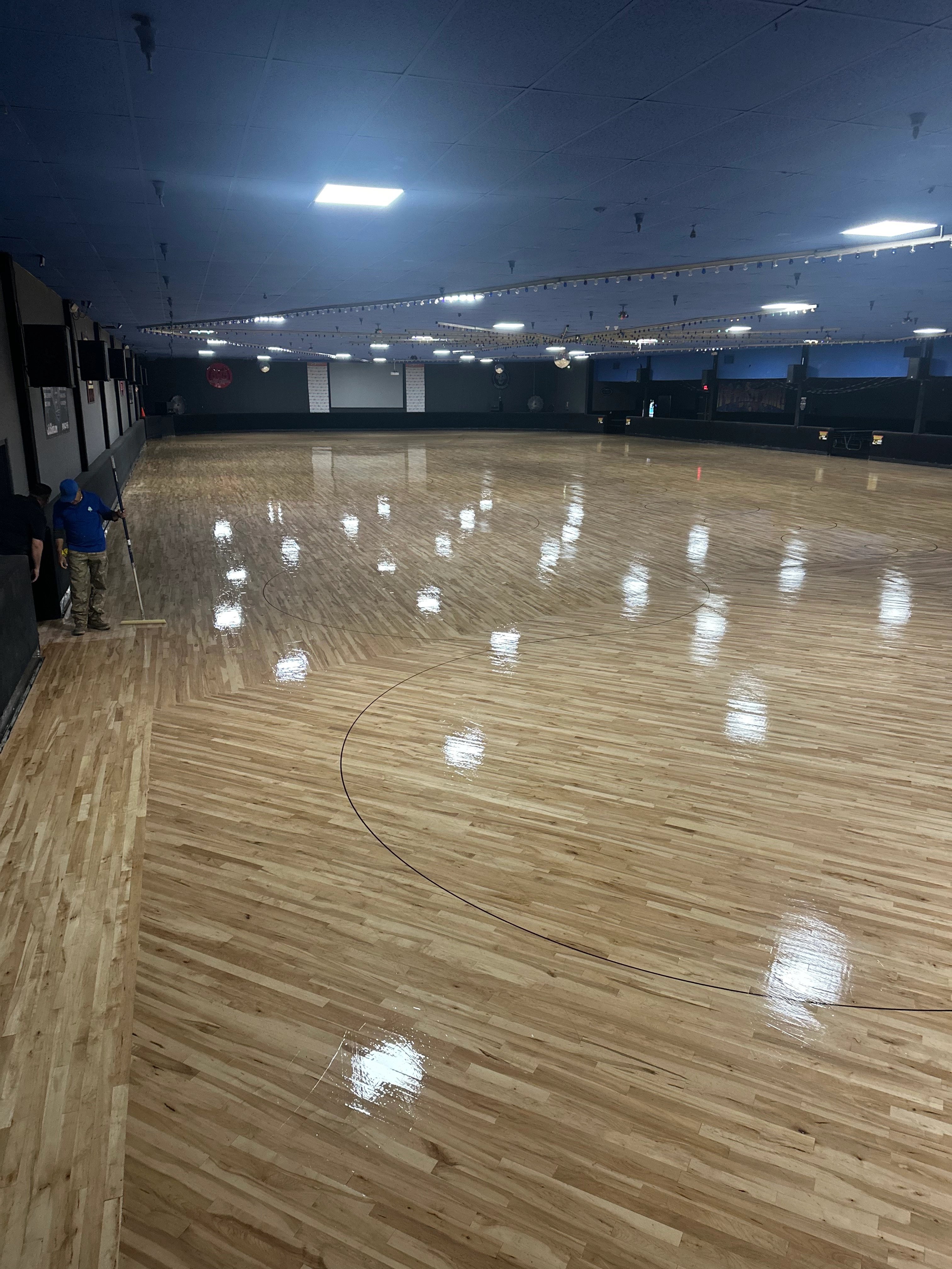 Commercial wood floor refinishing in a gymnasium-scale Inland Empire space