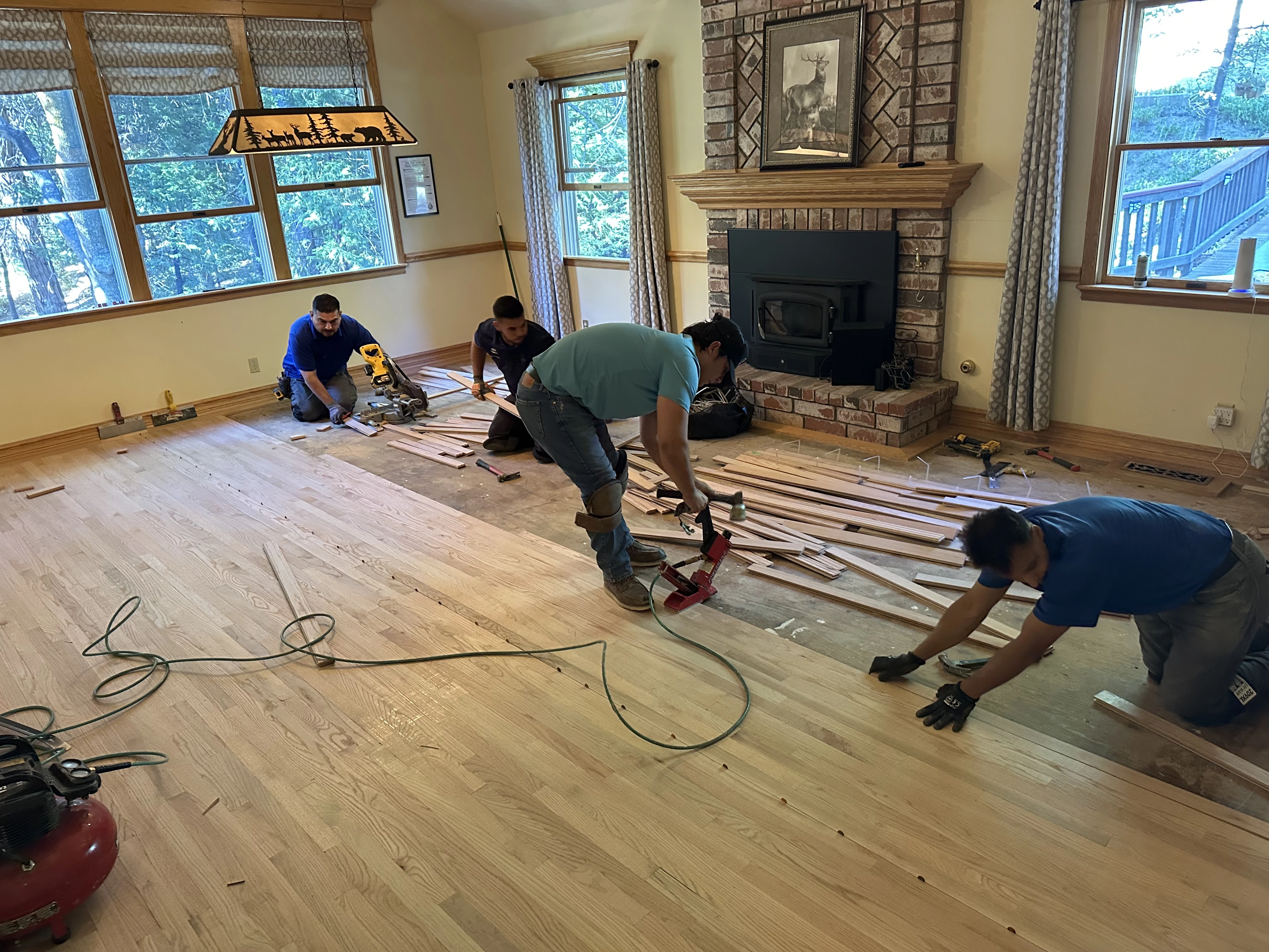 Professional flooring contractor team during a hardwood installation